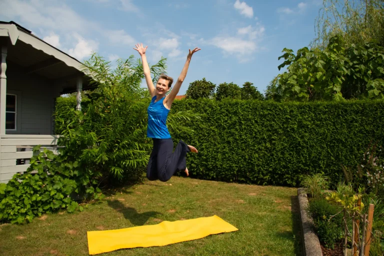 Im Garten trainiert Martina Lichtblau auf einer gelben Matte und springt vor Freude in die Luft.